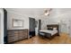 Bedroom with hardwood floors, stylish dresser, and decorative accents for relaxation at 4824 E Hummingbird Ln, Paradise Valley, AZ 85253