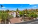 Stunning two-story home featuring a red tile roof, lush landscaping, and mountain views at 4824 E Hummingbird Ln, Paradise Valley, AZ 85253