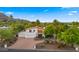 Striking home showcasing a modern design with a terracotta roof, lush landscaping, and a circular driveway at 4824 E Hummingbird Ln, Paradise Valley, AZ 85253