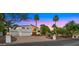 Beautiful home exterior with manicured landscaping, a three-car garage, and circular driveway at 4824 E Hummingbird Ln, Paradise Valley, AZ 85253