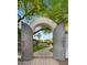 Elegant wrought iron gates open to reveal a serene garden path, promising a tranquil retreat at 4824 E Hummingbird Ln, Paradise Valley, AZ 85253