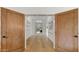 Elegant hallway with wood doors, hardwood floors, and designer lighting fixtures at 4824 E Hummingbird Ln, Paradise Valley, AZ 85253