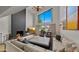 Cozy living room with a fireplace, large windows, and comfortable seating at 4824 E Hummingbird Ln, Paradise Valley, AZ 85253