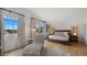 Bright main bedroom with a chaise lounge, hardwood floors, and private access to a patio at 4824 E Hummingbird Ln, Paradise Valley, AZ 85253
