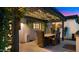 Inviting outdoor dining area with pergola, string lights, and a built-in television for entertainment at 4824 E Hummingbird Ln, Paradise Valley, AZ 85253