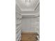 Large walk-in closet with custom shelving, hanging rods, and designer lighting at 4824 E Hummingbird Ln, Paradise Valley, AZ 85253