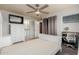 Bedroom features neutral carpet, ceiling fan, and ensuite bathroom at 520 N Stapley Dr # 117, Mesa, AZ 85203