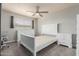 Bedroom with neutral carpet, ceiling fan, and white furnishings at 520 N Stapley Dr # 117, Mesa, AZ 85203
