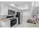 Kitchen featuring stainless appliances, a skylight, and tile floors at 520 N Stapley Dr # 117, Mesa, AZ 85203