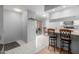 Bright and airy kitchen with a breakfast bar and an adjacent dining area with views through a sliding glass door at 520 N Stapley Dr # 117, Mesa, AZ 85203