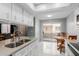 Kitchen features tile floors, light countertops, and a breakfast nook with access to back patio at 520 N Stapley Dr # 117, Mesa, AZ 85203