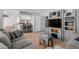 Open-concept living room with a view into the kitchen and custom wall unit perfect for a tv at 520 N Stapley Dr # 117, Mesa, AZ 85203
