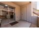 View of a patio with a sliding glass door leading to a kitchen, and a white service door at 520 N Stapley Dr # 117, Mesa, AZ 85203