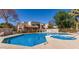 Community pool and hot tub area with surrounding landscaping and comfortable lounge chairs at 520 N Stapley Dr # 117, Mesa, AZ 85203