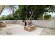 Backyard patio area with an outdoor kitchen, stone bar, and fire pit, ideal for entertaining at 524 W Fairway Dr # 10, Mesa, AZ 85201