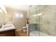 Bathroom featuring double sinks, marble countertops, and modern glass enclosed shower at 524 W Fairway Dr # 10, Mesa, AZ 85201