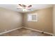 Bedroom with a ceiling fan, neutral walls, plantation shutters, and tile flooring at 524 W Fairway Dr # 10, Mesa, AZ 85201