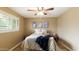 Cozy bedroom with neutral walls, a ceiling fan, and bright natural light from the window at 524 W Fairway Dr # 10, Mesa, AZ 85201