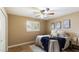 Bedroom with a ceiling fan, window with plantation shutters, and a bed with blue throw at 524 W Fairway Dr # 10, Mesa, AZ 85201