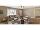 Bright living room featuring neutral tones, sleek furniture, and window with plantation shutters at 524 W Fairway Dr # 10, Mesa, AZ 85201