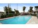 Community pool with sun-drenched lounging area, palm trees, and lush landscaping at 524 W Fairway Dr # 10, Mesa, AZ 85201
