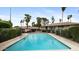 Community pool surrounded by lush greenery and palm trees offers a relaxing and refreshing escape at 524 W Fairway Dr # 10, Mesa, AZ 85201