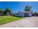 Well-maintained backyard features lush grass, a covered patio, and an expansive concrete driveway at 6121 N 11Th St, Phoenix, AZ 85014