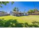 Large backyard with a covered patio area, green grass, and a well-kept perimeter fence at 6121 N 11Th St, Phoenix, AZ 85014