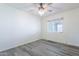 Bright bedroom with a modern ceiling fan, a window with natural light, and light gray wood-look floors at 6121 N 11Th St, Phoenix, AZ 85014