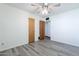 Neutral bedroom with a modern ceiling fan, light gray wood-look floors, and closet at 6121 N 11Th St, Phoenix, AZ 85014