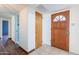 Warm entryway featuring a tile floor and wood door, leading to a bright and inviting hallway at 6121 N 11Th St, Phoenix, AZ 85014