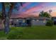 Charming single-story home boasts a well-maintained lawn, mature shade tree, and neutral exterior paint at 6121 N 11Th St, Phoenix, AZ 85014