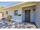 Inviting front entrance with a charming patio, decorative planters, and a secure screen door at 6121 N 11Th St, Phoenix, AZ 85014