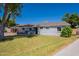 Charming single-story home with a well-manicured lawn and mature tree providing shade at 6121 N 11Th St, Phoenix, AZ 85014