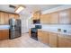 Kitchen with stainless steel appliances, light wood cabinets, and tile floors at 6121 N 11Th St, Phoenix, AZ 85014