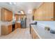 Well-lit kitchen with stainless steel appliances and light wood cabinets at 6121 N 11Th St, Phoenix, AZ 85014