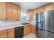Well-lit kitchen featuring stainless steel refrigerator and black appliances at 6121 N 11Th St, Phoenix, AZ 85014