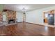 Inviting living room with a stone fireplace, hardwood floors, and seamless flow into the kitchen at 6121 N 11Th St, Phoenix, AZ 85014