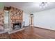 Cozy living room featuring a stone fireplace and hardwood floors at 6121 N 11Th St, Phoenix, AZ 85014