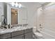 A modern bathroom featuring a double vanity with granite countertops, a soaking tub, and tiled shower at 6623 E Marisa Ln, Phoenix, AZ 85054