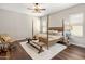 Cozy bedroom with a four-poster bed, ceiling fan, and warm, inviting decor at 6623 E Marisa Ln, Phoenix, AZ 85054