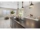 Open kitchen featuring modern fixtures, an eat-in island, and adjoining living area at 6623 E Marisa Ln, Phoenix, AZ 85054