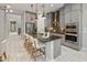 Modern kitchen boasts gray cabinetry, stainless steel appliances, and a spacious island with barstool seating at 6623 E Marisa Ln, Phoenix, AZ 85054