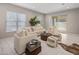 Bright living room featuring neutral-toned furniture, large windows, and sliding glass door to outdoor space at 6623 E Marisa Ln, Phoenix, AZ 85054