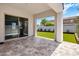 A covered patio area with tiled flooring offering views of the landscaped backyard with new grass at 6623 E Marisa Ln, Phoenix, AZ 85054