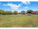 Community playground featuring a green slide, shaded seating, and a lush grassy play area for outdoor activities at 6623 E Marisa Ln, Phoenix, AZ 85054