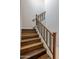 Wooden staircase with iron railing adds a touch of elegance to the home's interior at 6623 E Marisa Ln, Phoenix, AZ 85054
