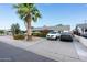Inviting home with a palm tree, lush bushes, and gravel landscaping leading to a paved driveway at 7255 E Coronado Rd, Scottsdale, AZ 85257