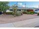 Well-maintained home with a desert-landscaped front yard, featuring a variety of cacti and greenery at 7255 E Coronado Rd, Scottsdale, AZ 85257