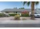 Cozy home showcasing vibrant flowers and manicured shrubs along the front yard landscape at 7255 E Coronado Rd, Scottsdale, AZ 85257